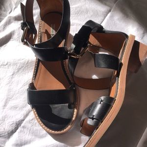 Black leather, silver buckled with a slight heel.